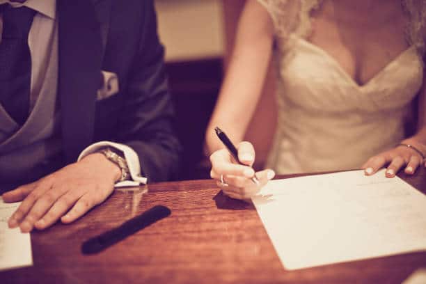 pareja firmando el acta matrimonial